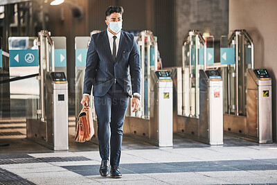 Buy stock photo Covid, health and safety on public transport, a businessman walking in a bus or train station in a business suit and face mask. Career, travel and an office worker on his morning journey in the city.