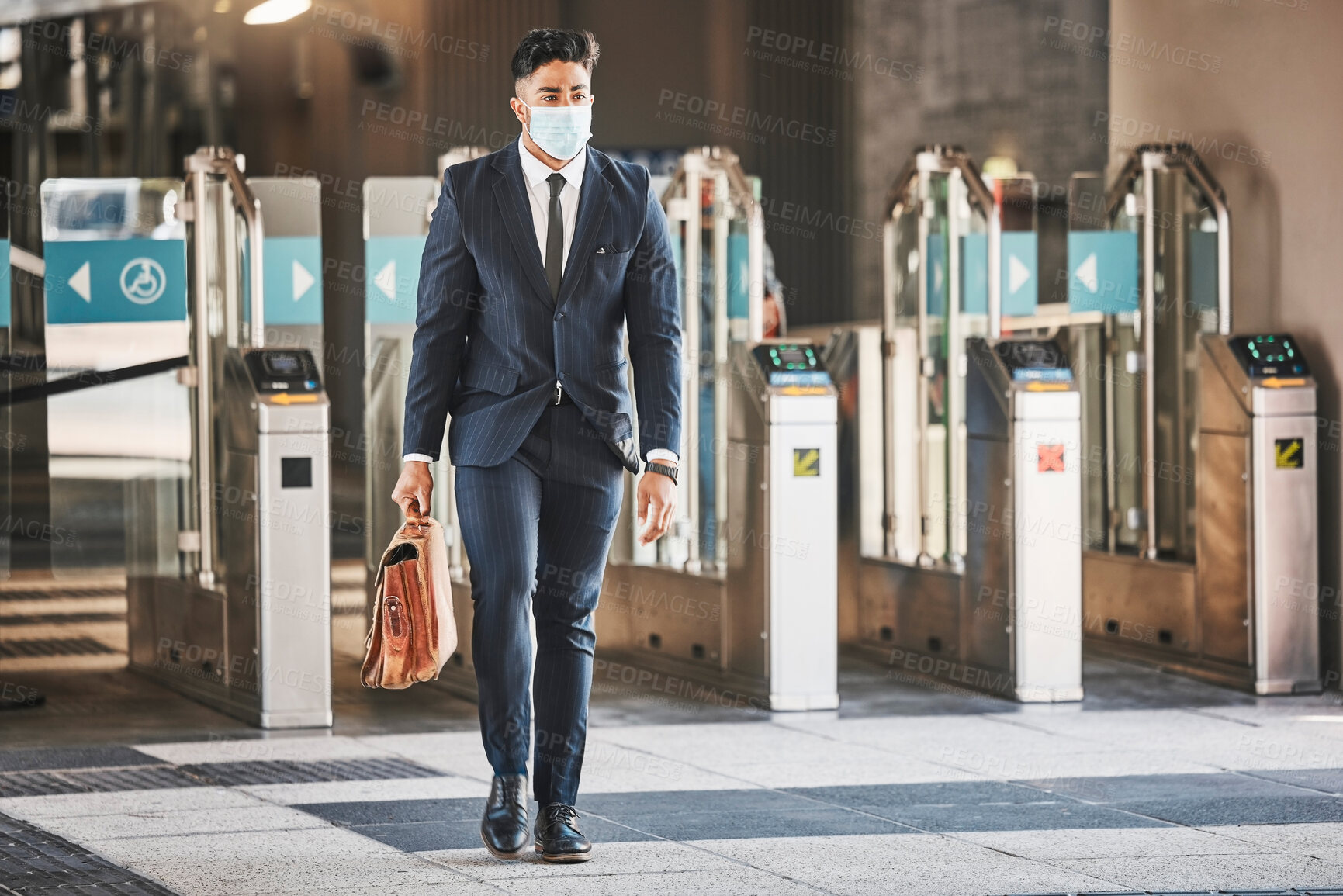 Buy stock photo Covid, health and safety on public transport, a businessman walking in a bus or train station in a business suit and face mask. Career, travel and an office worker on his morning journey in the city.