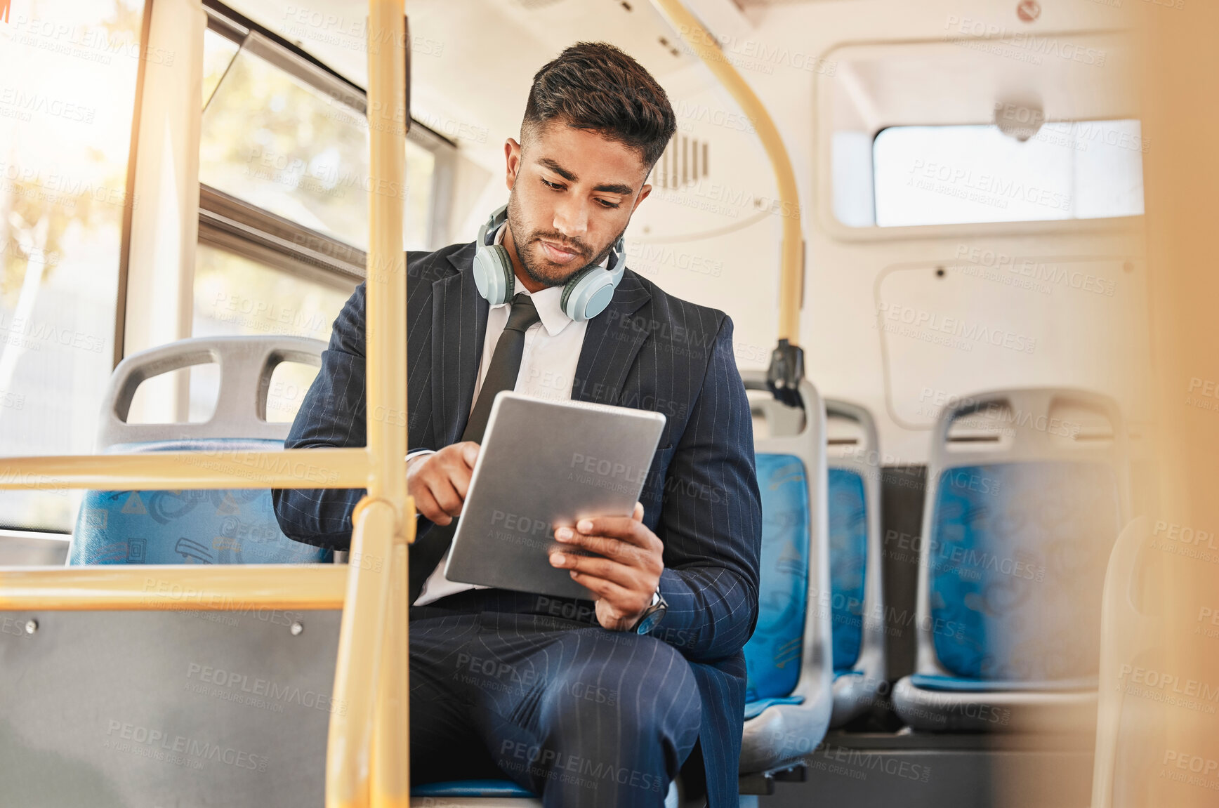 Buy stock photo Business man, using tablet and bus for travel to work, home or working location. Relax businessman using headphones, public transport to cbd and mobile device to update social media or check schedule