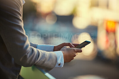 Buy stock photo Businessman hands typing on phone outdoors in communication, reading and texting online in urban city bokeh. Man with smartphone or digital mobile device on social media app or internet website
