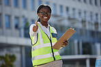 Thumbs up, success and motivation by health and safety construction worker thank you for support of goal or vision. Happy black woman holding building inspection list, showing winning, trust sign