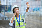 Construction worker, maintenance and development woman multitask on a phone while working. Building management employee on a work call helping holding up a hand on a contractor and builder job site