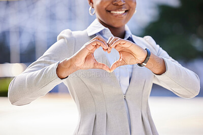 Buy stock photo Love and a smile, a business woman makes a heart sign with her hands. Black, corporate office worker and a gesture of respect and friendship with her fingers, happy with work and success in the city