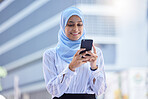 Islam, islamic or business woman on her phone in hijab texting in the city with mockup. Diversity, muslim and arabic international employee on mobile working in town or global corporate company.