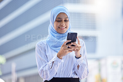 Buy stock photo Islam, islamic or business woman on her phone in hijab texting in the city with mockup. Diversity, muslim and arabic international employee on mobile working in town or global corporate company.
