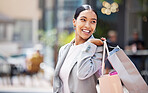 Shopping, retail and customer with bags to shop at a store or mall in the city. Sale, money and consumer lifestyle with a happy, young woman spending, buying and purchase against an urban background