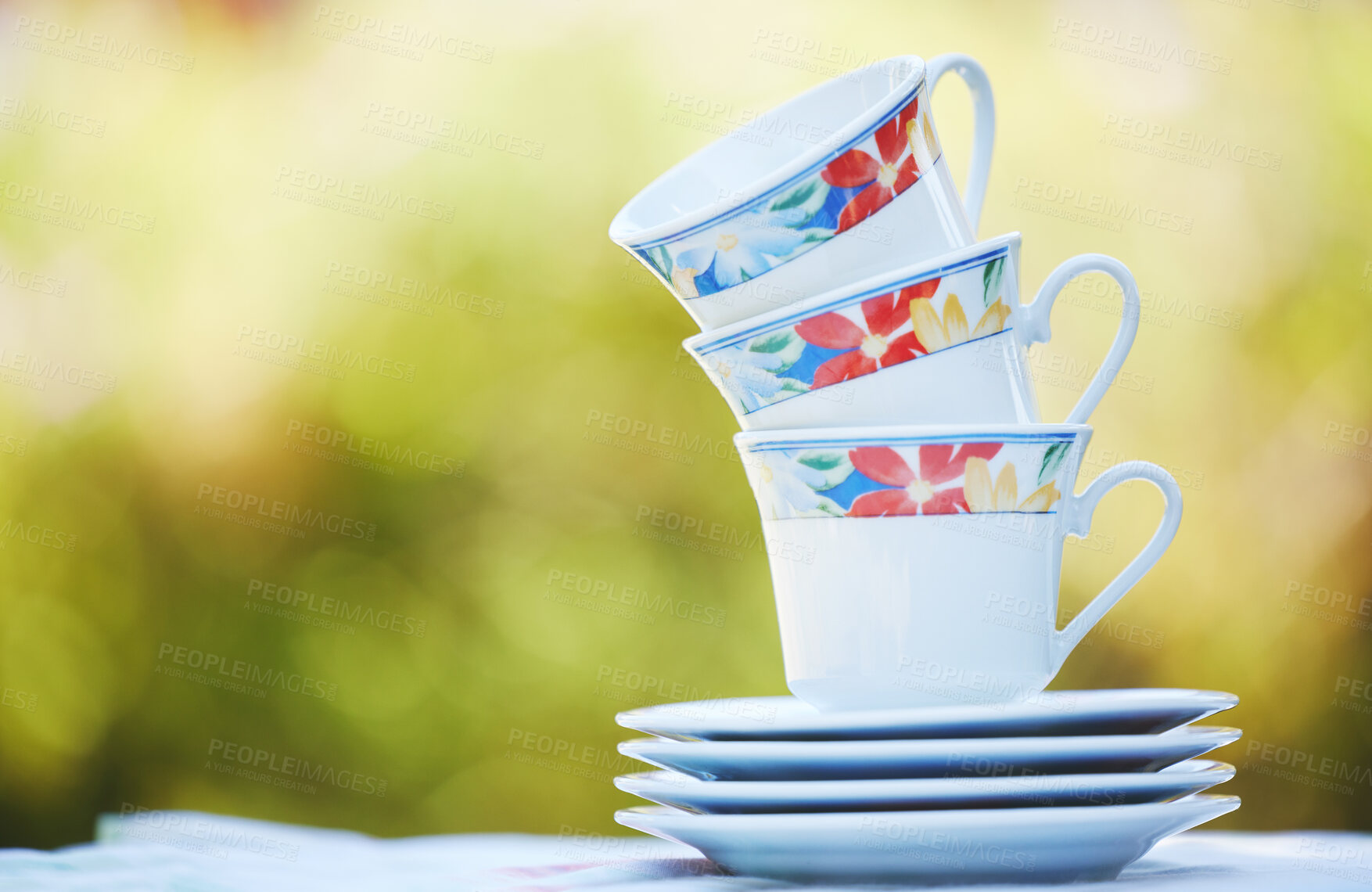 Buy stock photo Garden cups, flowers and spring print china tea set for a calm morning in a backyard or park with a hot drink. Outdoors floral porcelain crockery catering for a relax, zen and quiet day in nature