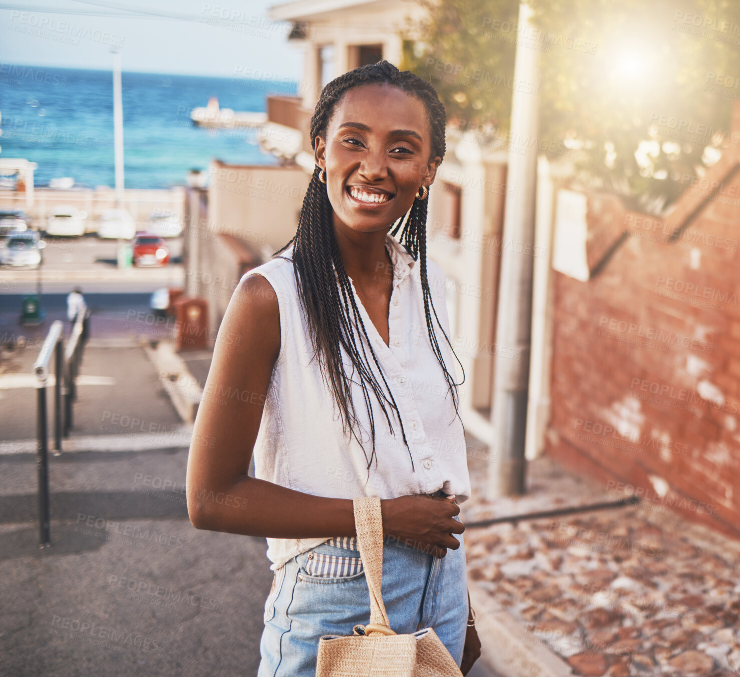 Buy stock photo Happy smile black woman on vacation in city by sea or ocean water port side on sunshine summer holiday travel. Portrait of joy, excited and smiling black girl person on sun flare urban outdoor street
