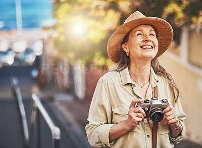 Buy stock photo Happy photographer tourist taking photo of historic building with camera, smiling and carefree. Excited mature female solo travel journey, enjoying retirement while looking at bucket list destination
