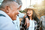 Happy senior woman in nature with friends while taking an outdoor walk in spring. Smiling mature woman having a conversation with a man outside. Old smiling lady having fun while hiking with aged men