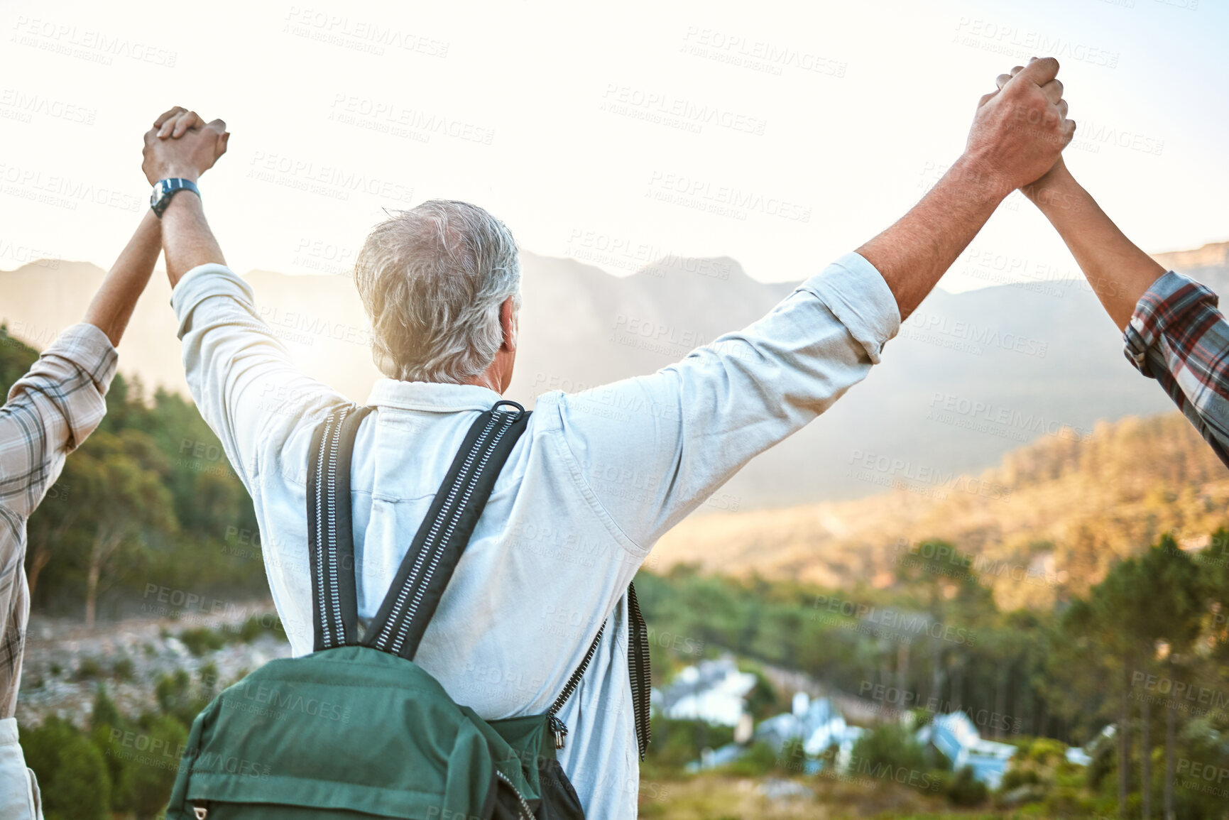 Buy stock photo Happy senior man hiking with friends, a celebration of the mountain view after holiday adventure trail in nature. Exercise to stay active, fit and healthy for lifestyle of wellness into retirement