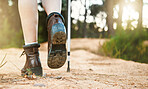 Hiking, walking and active feet closeup of an outdoors hike, walk and adventure on a mountain trail. Relaxing, freedom and carefree activity outside in nature on a sunny summer day in the mountains