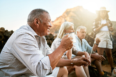 Buy stock photo Relaxed senior camping with friends, taking a break and drinking a cup of coffee while enjoying retirement keeping healthy outdoors in nature. Smiling retired man on a getaway wellness retreat