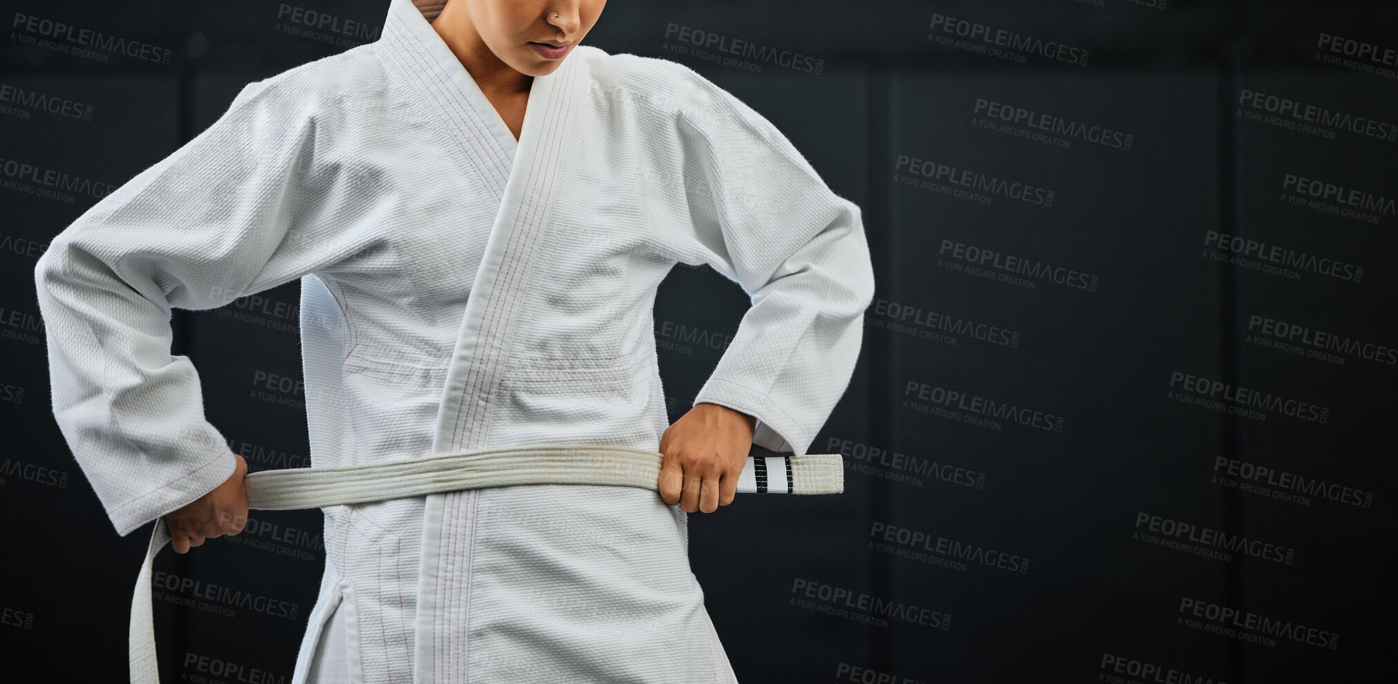 Buy stock photo Beginner, karate and student getting ready for the first day of self defense training against a dark background in a dojo. Determined learner in motivation for fighting lessons in the martial arts.