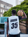 Basketball, sports and fitness exercise of a sport player on an outdoors court for a workout. Back of a strong man and athlete with a ball ready to start cardio, active or game match training outside