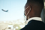 Businessman in an airport for work travel during covid with a mask and plane fly in the background. Entrepreneur, employee or corporate professional watching an airplane while waiting to board flight