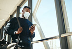 Business, travel and covid with a businessman on his phone about to board an airplane flight. Corporate professional black man texting about work and walking in an airport on an international trip.