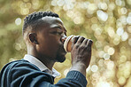 Businessman with drink coffee cup in a park with trees, nature and bokeh background. Calm black man, corporate professional worker or employee on coffee break with espresso in the morning before work