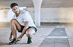Fitness, running and exercise, a man going on a run in the city. Motivation, cardio and training, a runner lacing his sports shoes before an outdoor workout for a healthy body and an active lifestyle