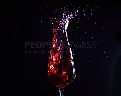 Buy stock photo Wine, alcohol or drink glass and splash on black studio background for celebration, cheers or restaurant toast. Zoom, red creative texture or fruit beverage in liquid motion at event or birthday