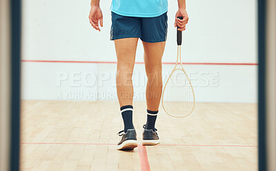 Buy stock photo Rear view of unknown squash player walking alone on court and holding racket before game. Fit active mixed race athlete getting ready for training and practice in sports centre. Sporty hispanic man
