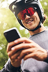 Adventure, sports man with smartphone in forest check GPS location, fitness goal or progress on mobile app. Athletic in nature reading online results, web for triathlon tips on 5g network mobile app