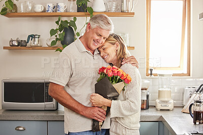 Buy stock photo Flower bouquet, hug and senior couple with smile for celebration of marriage in kitchen of their house. Elderly man and woman giving roses as gift while hugging for love, anniversary or birthday