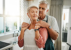 Senior, couple and love in kitchen for embrace together in romance, care and bonding in home. Elderly man, woman and retirement show happiness, relax and happy look on face in house in Houston, Texas