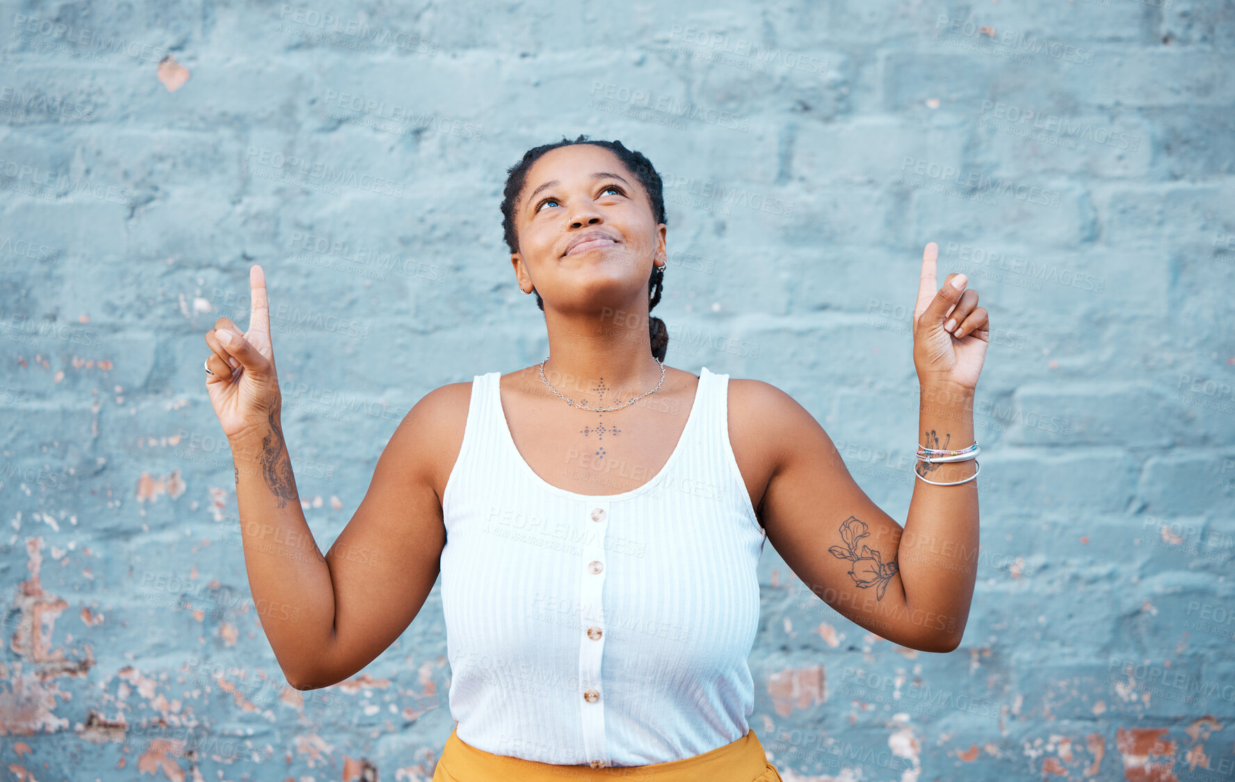 Buy stock photo Smile, happy or comic black woman pointing up by building city wall background mockup design for marketing. Fashion, trend or style model or fun and cool Nigerian student by advertising mock up space