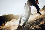 Action, mountain bike and man training in dirt, dust for sports, adventure or outdoor marathon travel with blue sky mockup advertising. Risk, danger and motorcycle person with challenge speed closeup