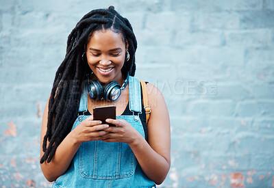 Buy stock photo Black woman with 5g smartphone for social media typing, digital chat app or check location on blue wall background space mockup. Teenager gen z girl on cellphone for youth online website networking