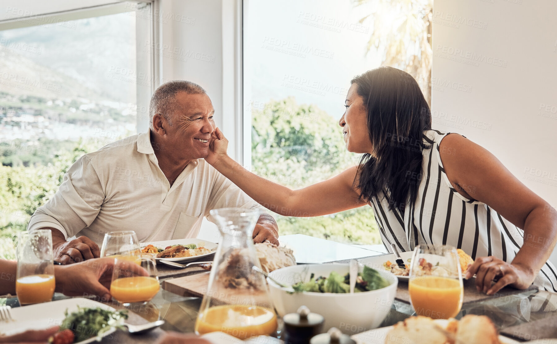 Buy stock photo Senior couple, love bonding or food in house, home or restaurant in thanksgiving, marriage anniversary or celebration event. Smile, happy or retirement elderly man and Mexican woman with festive meal