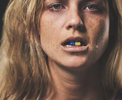 Buy stock photo Depression, portrait and girl with pill in her mouth with emotional tears on face from crying. Sad, unhappy and isolated woman with mental health problem taking psychiatry medicine closeup.

