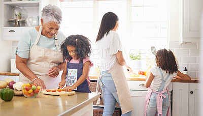 Buy stock photo Black family cooking, children learning and grandmother teaching girl for healthy lunch and growth development in kitchen together. Senior woman and mom with kids make salad or vegetable food in home
