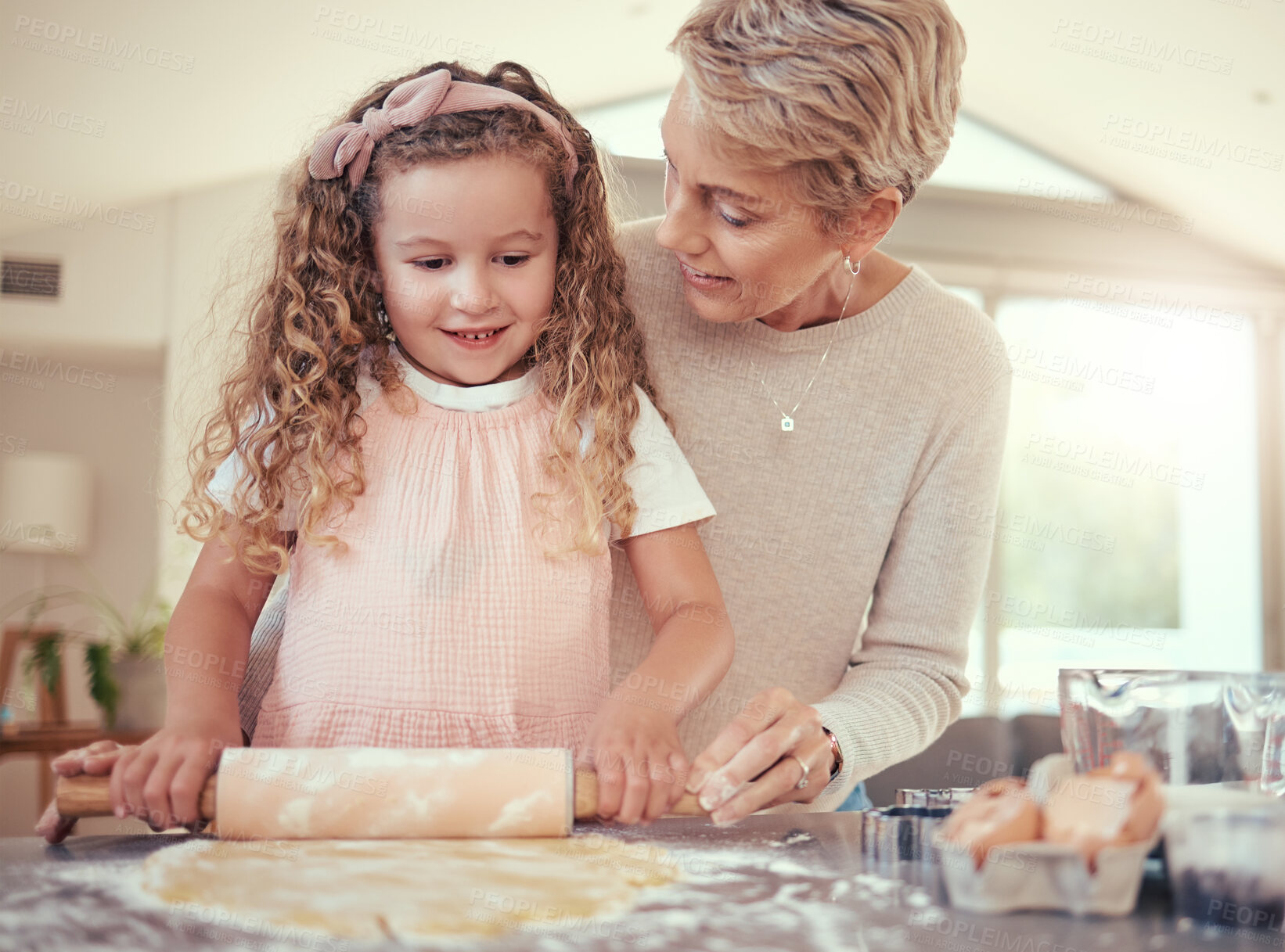Buy stock photo Family, learning and girl baking with grandmother in a kitchen, bonding while prepare cookies together. Teaching, independence and child development by senior woman showing child how to bake snack