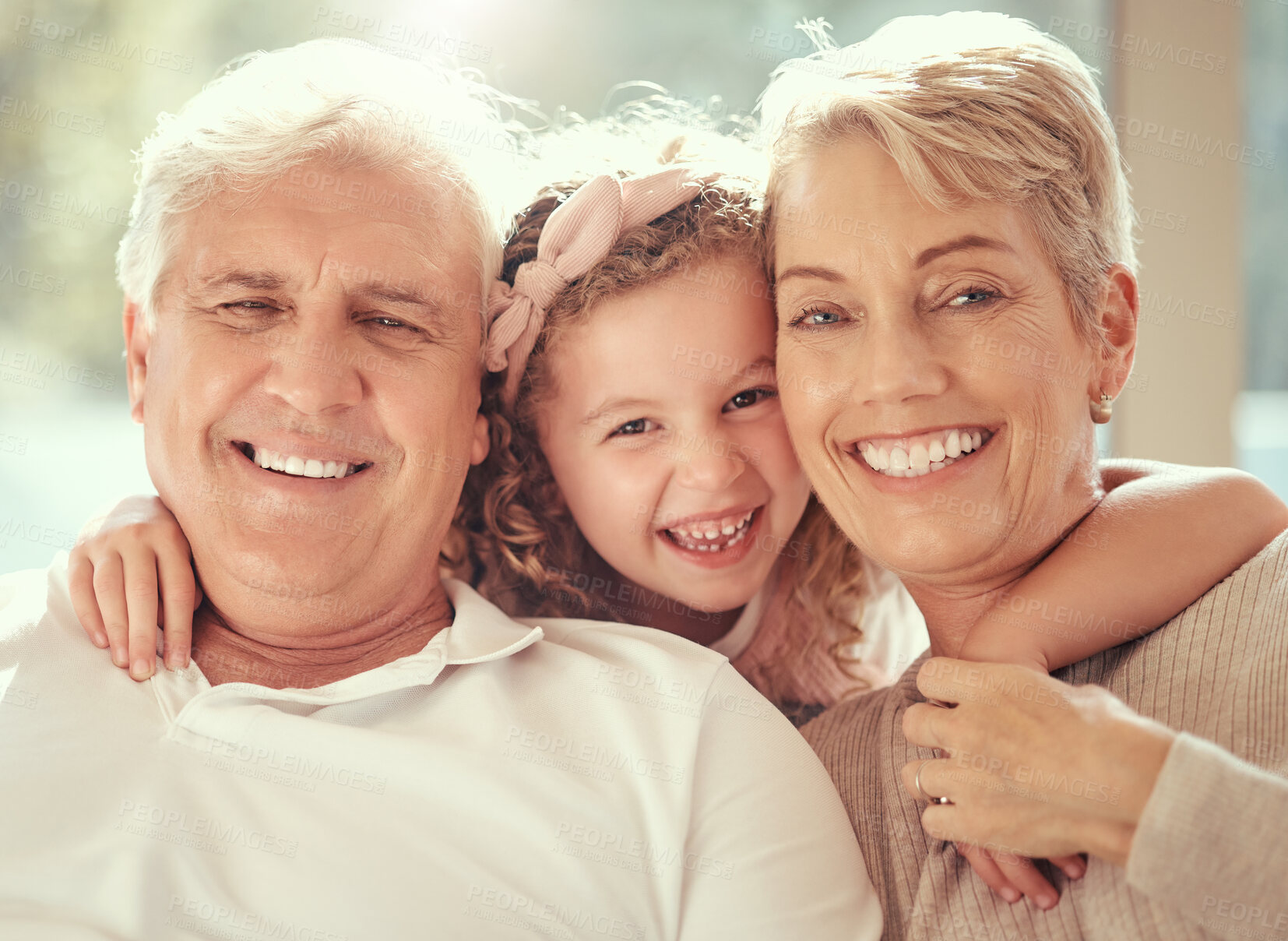 Buy stock photo Happy family, children and grandparents hug and bond in living room together, cheerful and content in their home. Relax, smile and face portrait of girl embracing senior man and woman and having fun