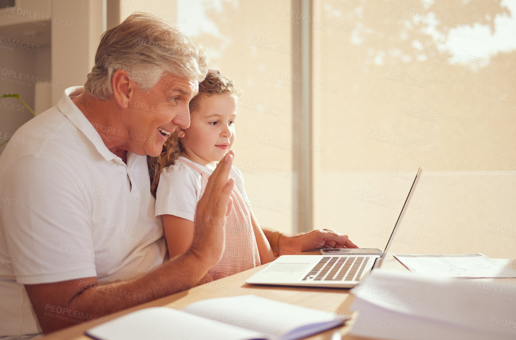 Buy stock photo Elderly man, laptop and child on video call speaking and waving while relaxing in the family home. Happy, smile and grandfather and little girl greeting on a virtual call with a computer in the house