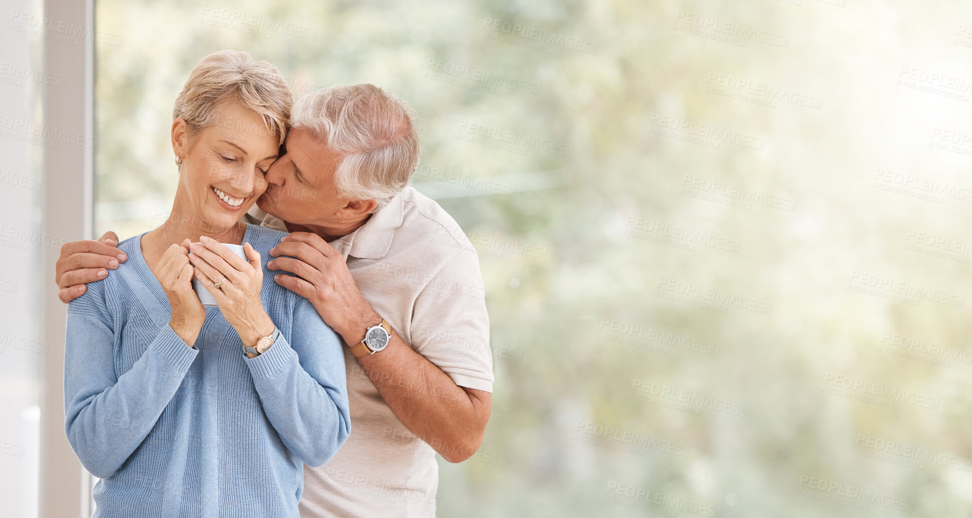 Buy stock photo Coffee morning, kiss and senior couple with smile during breakfast in retirement house at window with mockup space. Elderly man and woman with love and hug during holiday in Portugal and drink of tea