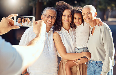 Buy stock photo Phone, screen and happy family relax and smile while posing for a picture outdoors together, loving and embracing. Child, mother and grandparents bonding on a trip in nature, hug and enjoy summer