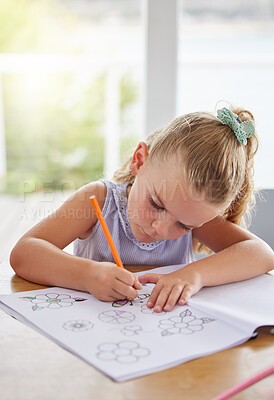 Buy stock photo Education, art and girl learning to draw at a table, having fun with colors and paper sketch in her home. Growth, development and creative activity for young learner looking serious about picture