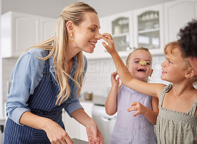 Buy stock photo Family baking and mother teaching children to bake cake in the kitchen of their home. Happy girl kids and woman play, cooking and laugh together while learning about food and being playful in home