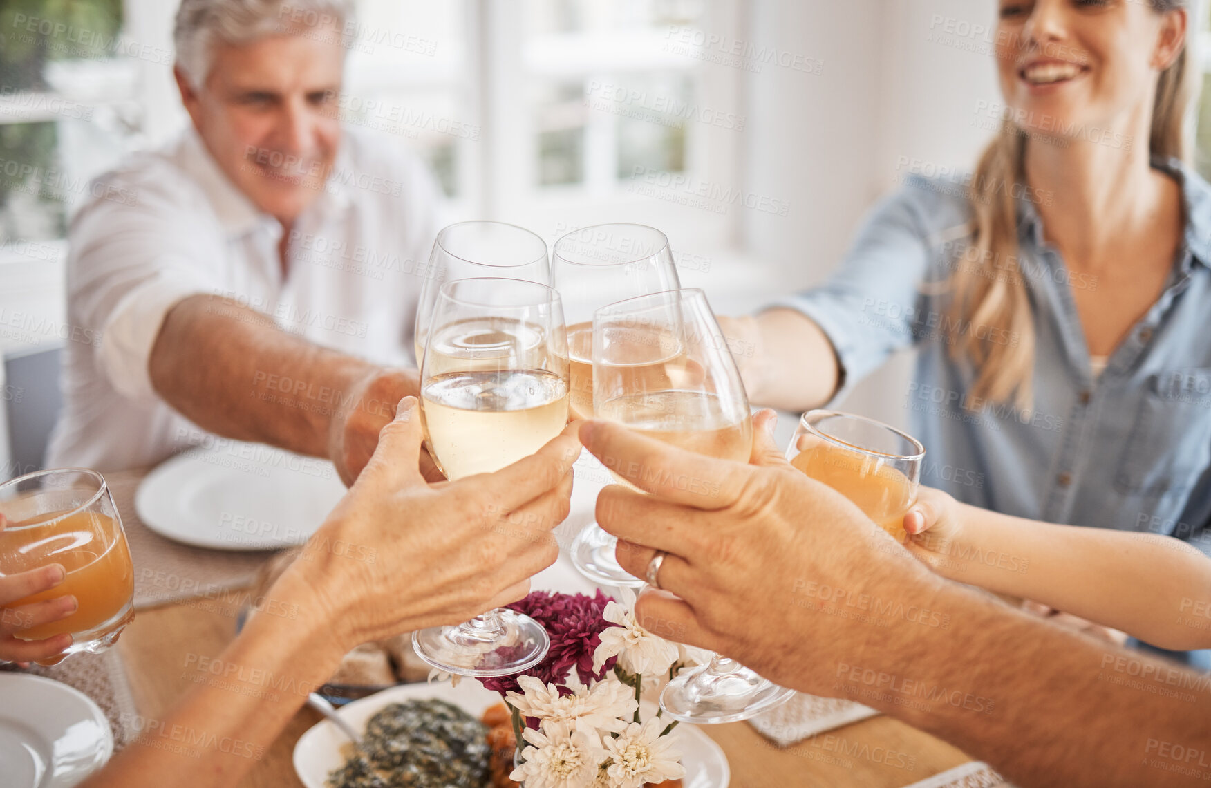 Buy stock photo Wine, toast and happy family celebration at a table, bonding and sharing a meal in their family home together. Love, relax and cheerful group toasting with drinks, enjoying quality time at gathering