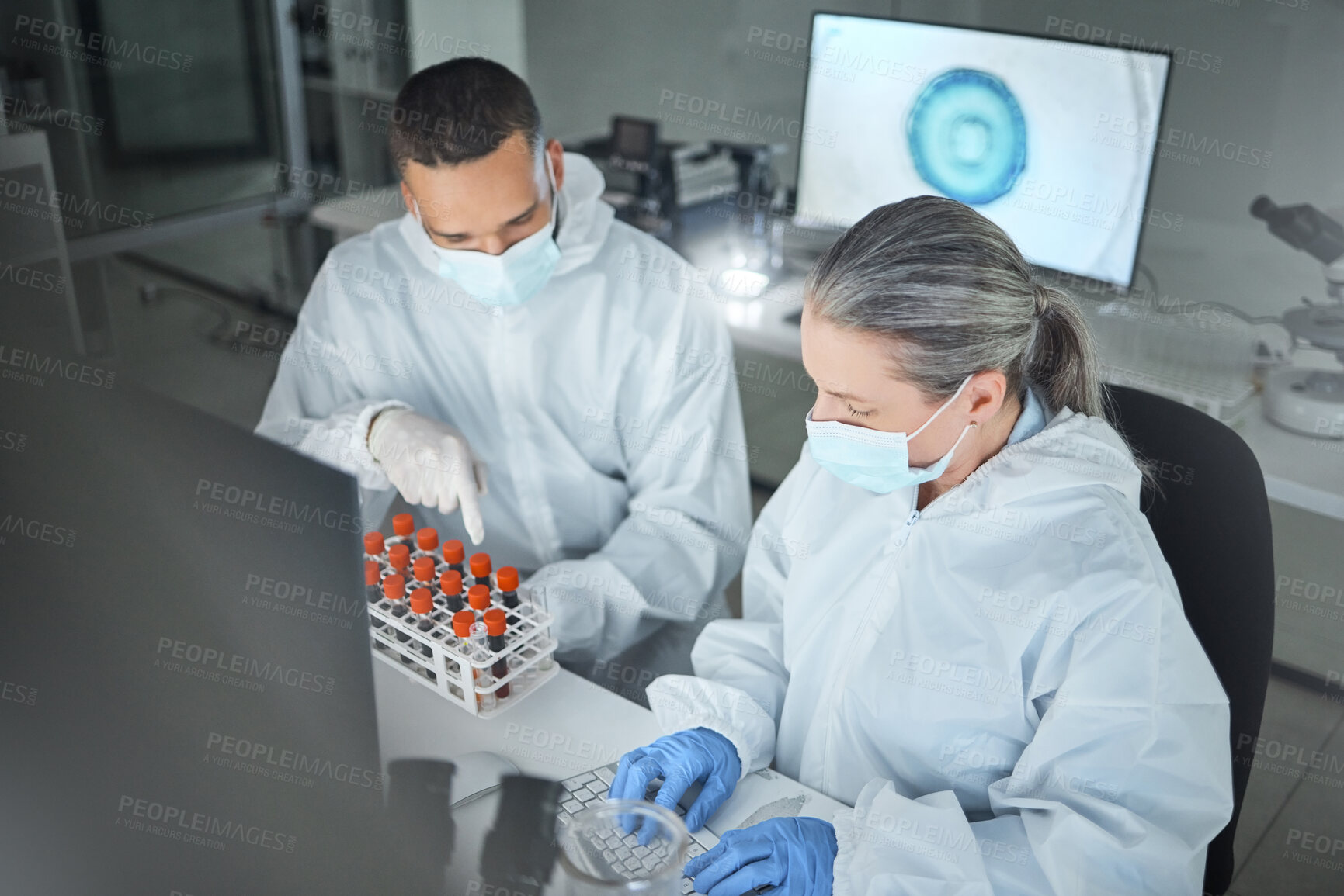 Buy stock photo Covid research, blood lab and scientist working on science data for hospital with employee together at work. Healthcare technician on the internet typing email about medical results with face mask