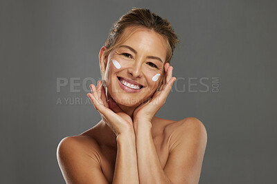 Buy stock photo Face, skincare and cream for mature woman for skin safety, health and wellness against grey mockup studio background. Portrait of a happy and healthy elderly model with sunscreen cosmetics for beauty