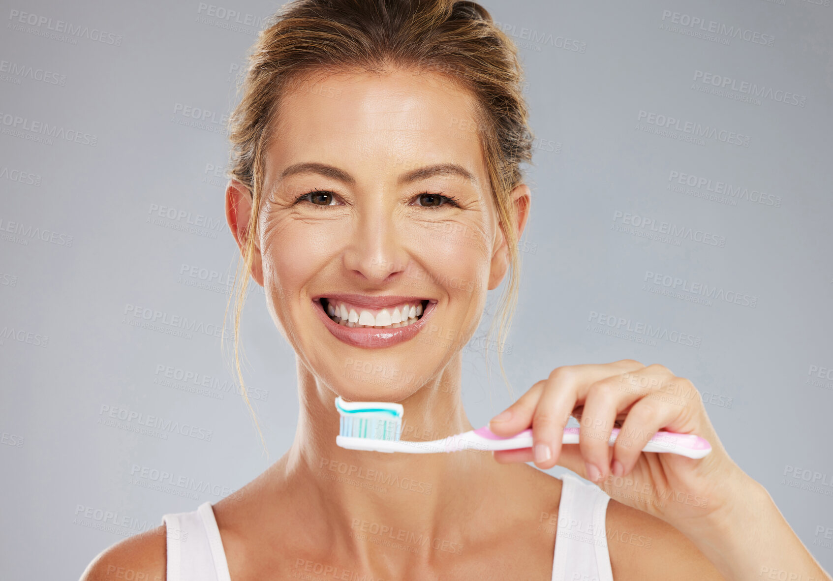 Buy stock photo Senior woman and portrait with toothbrush for dental treatment and teeth whitening at grey studio. Mature, healthy and happy lady with toothpaste for mouth cleaning and white smile face mockup.

