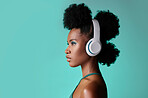 Music, designer headphones and black woman thinking while listening to podcast against a blue mockup studio background. African model streaming audio from radio with creative idea nd mock up space