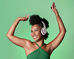 Green screen music, radio dance and black woman with smile while streaming podcast against a mockup studio background. Happy and smile African person with dancing energy from audio with headphones