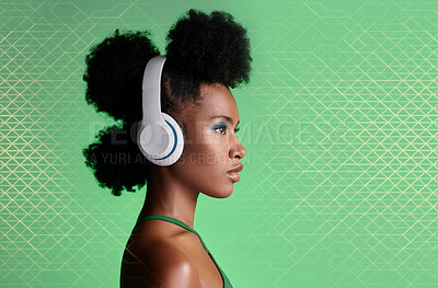 Buy stock photo Black woman, music headphones and fashion hairstyle on studio background with green geometric patterns and makeup cosmetics. Style, trend or pride for beauty model listening to Jamaican radio podcast