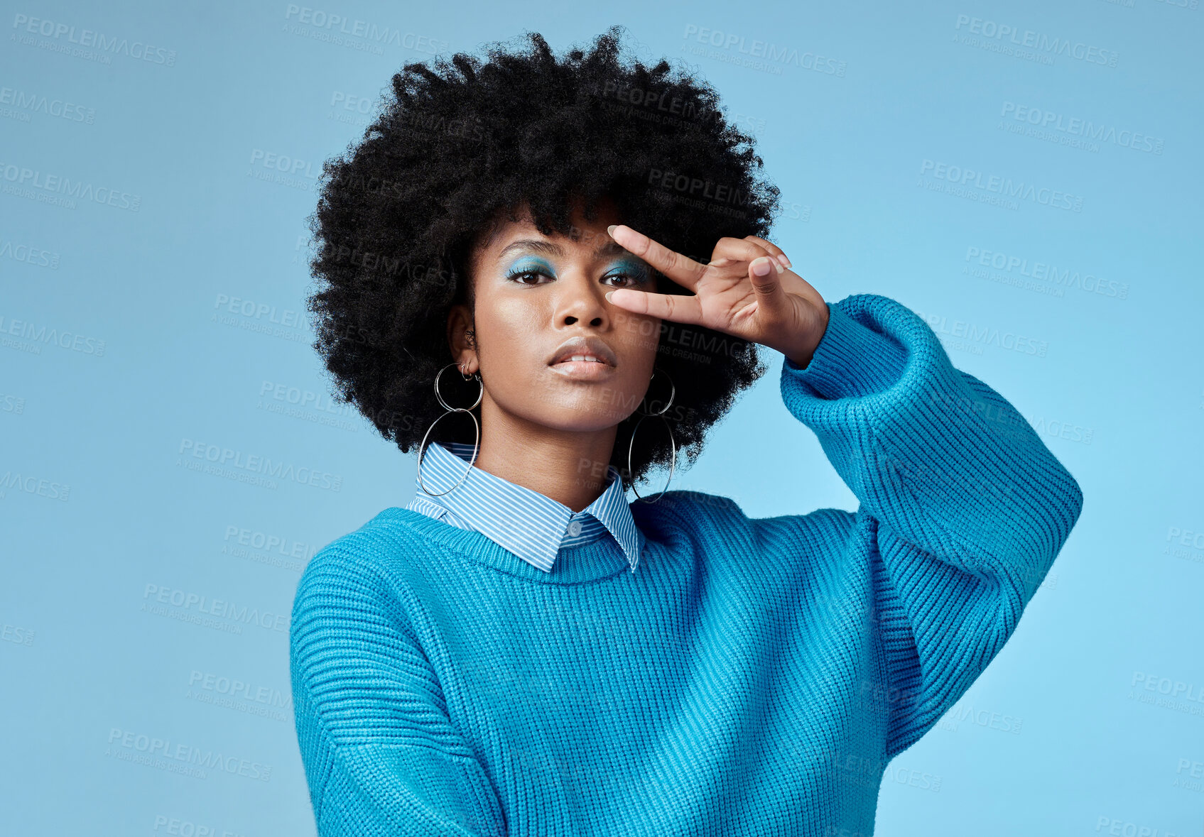 Buy stock photo Portrait, young and black woman shows peace, sign and with blue studio background, afro and stylish look. Girl, happy lady and female with confident, relax and casual or funky outfit for fun day. 