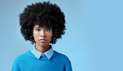 Buy stock photo Portrait of black woman, fashion afro and serious face with an expression of focus on blue background studio mockup. Trendy earing accessory, stylish cool clothing and blue cosmetic eyeshadow makeup 